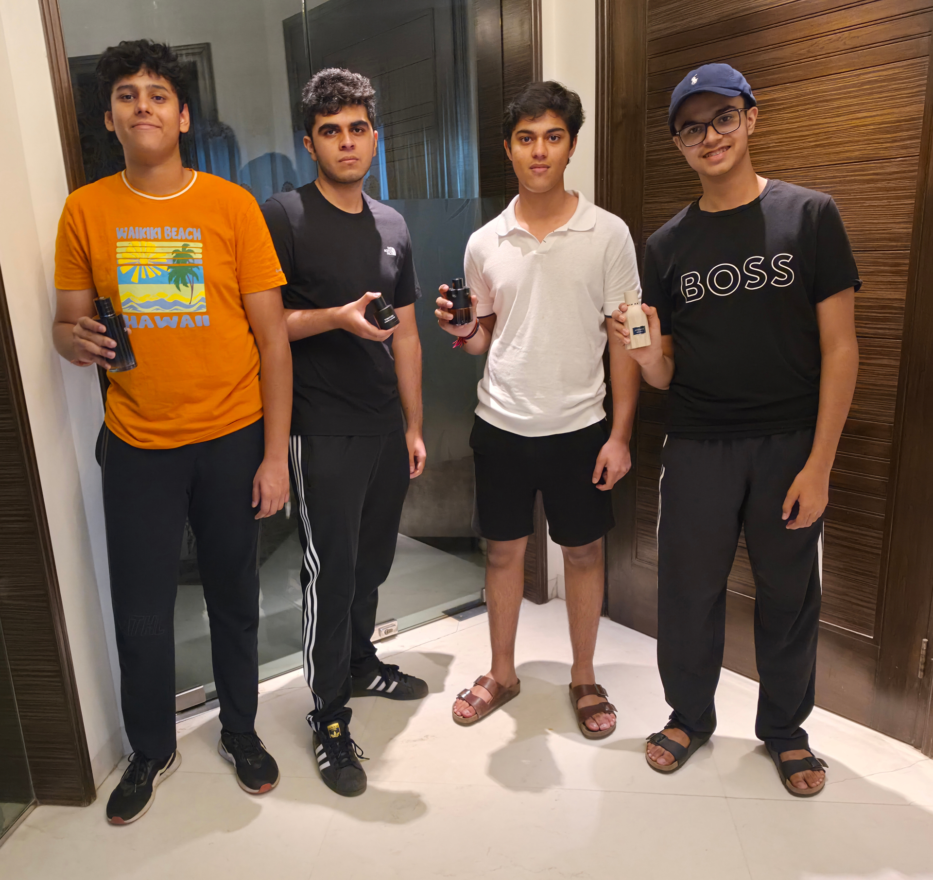 The four founders of Scentory holding fragrance bottles